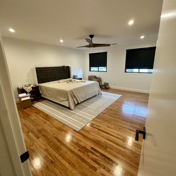 Master bedroom in Birdland, expanded 12 feet, with hardwood floors, recessed lighting and a ceiling fan