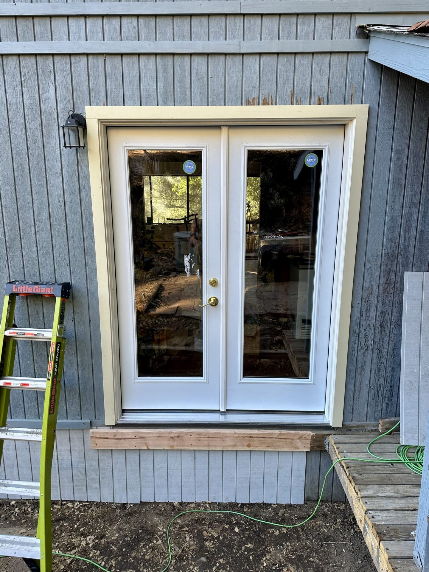 After: new white French doors with trim installed on a Descanso home