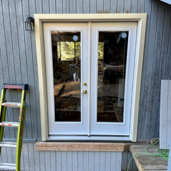 After: new white French doors with trim installed on a Descanso home