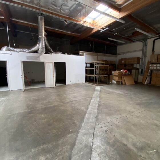 Before: empty Miramar warehouse with a concrete floor before the gym conversion