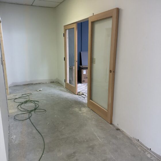 New interior office with wood-framed glass doors in the Miramar gym build-out