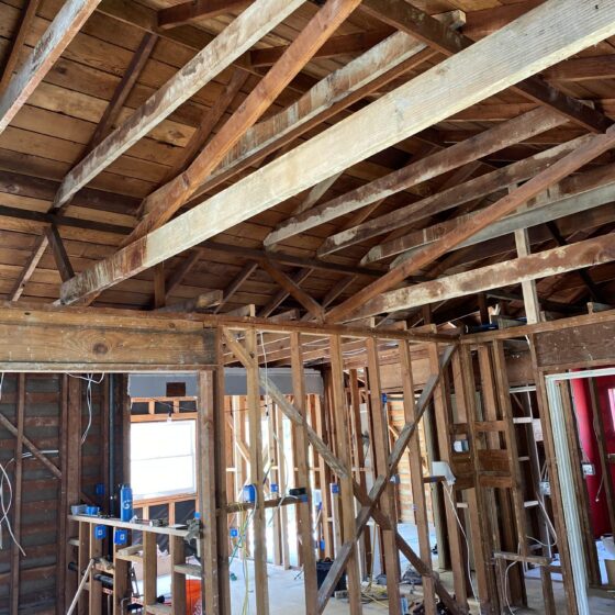 Exposed rafters and framing during a ceiling vault in a Point Loma home