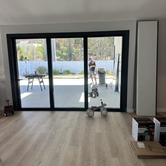 11-foot La Cantina multi-slide door opening from a Scripps Ranch addition to the patio