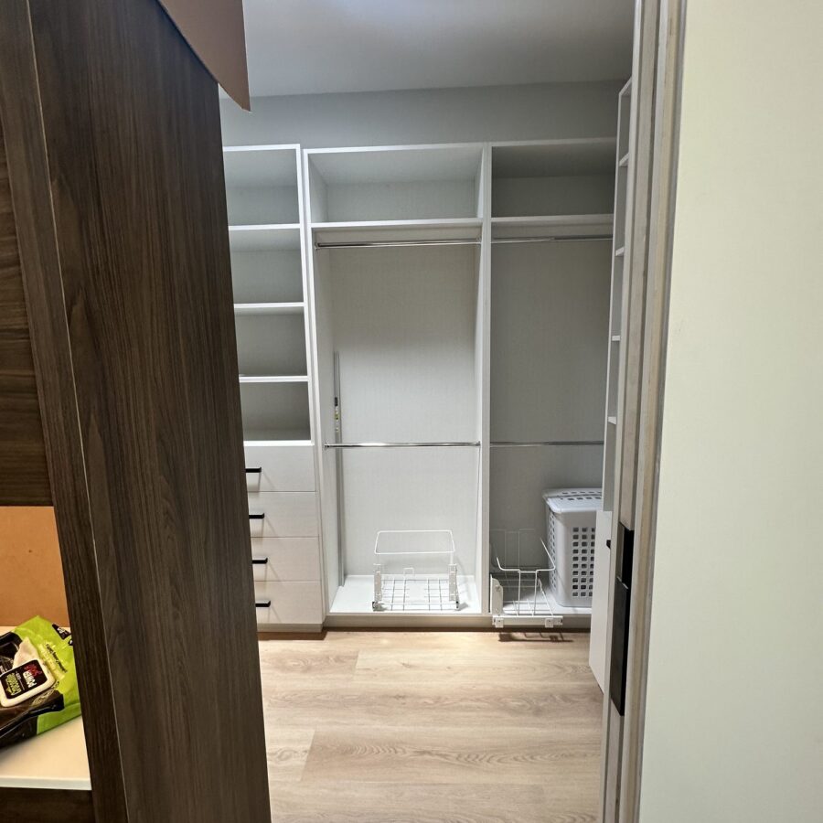 Walk-in closet with white built-in shelving in a Scripps Ranch addition