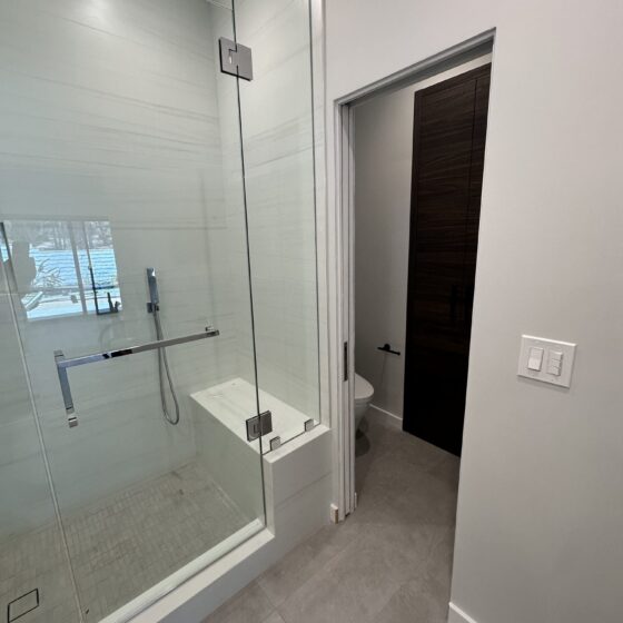Frameless glass shower with a bench in a Scripps Ranch addition bathroom