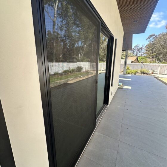 Large Andersen sliding door opening to the covered patio on a Scripps Ranch addition